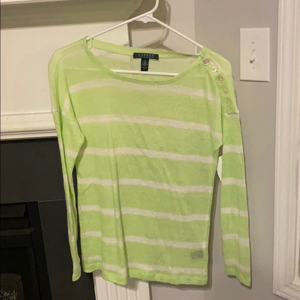 Sheer sweater with buttons on the sleeve.